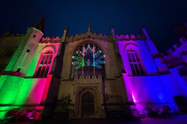Magdalen College Oxford illuminated in pink, green, blue and purple